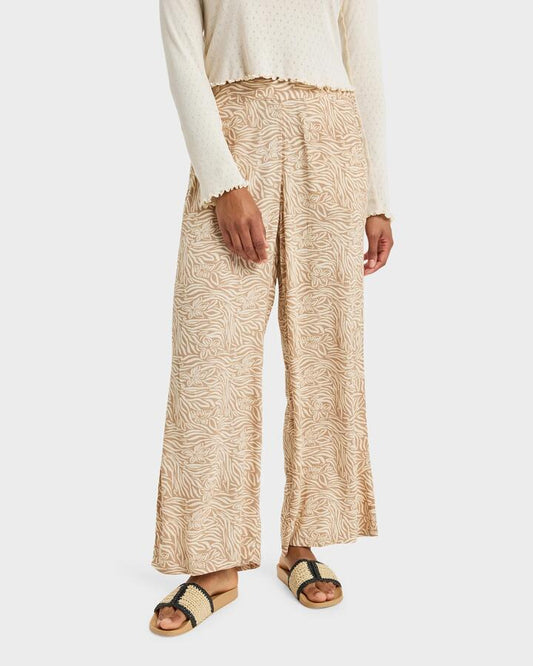 Image of a model wearing Pants. Product name - Roxy Womens Midnight Avenue Pants Parchment Animal Floral in Parchment Animal Floral colour by brand - Roxy