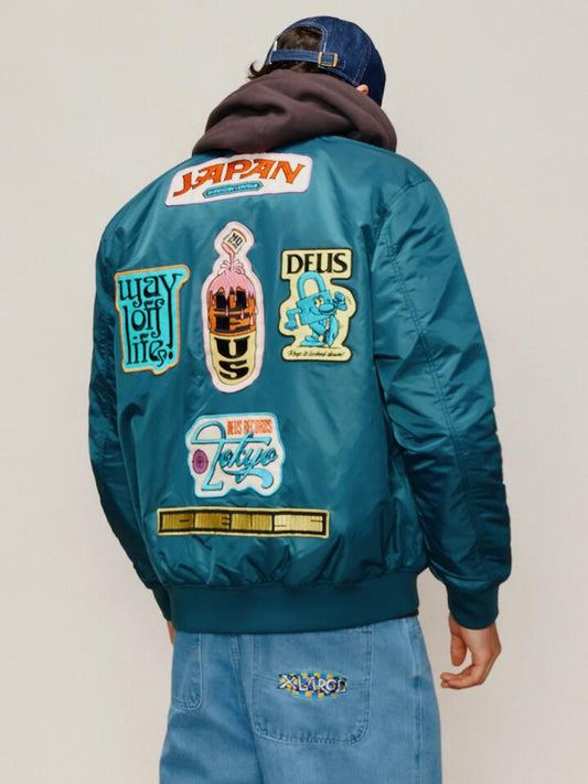 Image of a model wearing Outerwear. Productname: Deus Troglodyte Reversible Bomber Jacket in Teal Black colour by brand - Deus
