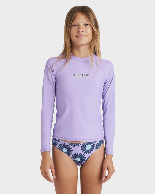 Image of a model wearing Tops. Product name - Billabong Girls 6-16 Heat Wave Long Sleeve Rash Vest Light Purple in Light Purple colour by brand - Billabong
