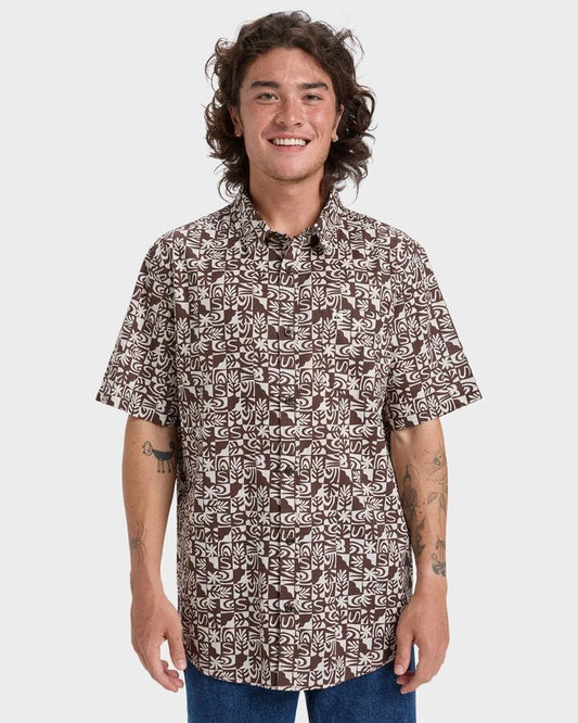 Image of a model wearing Tops. Productname: Quiksilver Mens Apero Classic Short Sleeve Shirt Chocolate Brown Mini Desert Ch - in Chocolate Brown Mini Desert Ch colour by brand - Quiksilver
