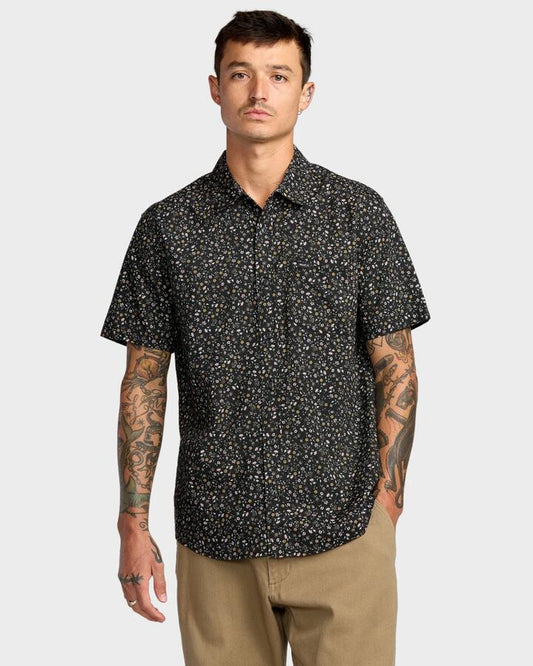Image of a model wearing Tops. Productname: RVCA Mens Botanical Short Sleeve Shirt Black Floral - in Black Floral colour by brand - RVCA