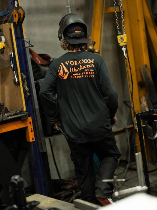 Image of a model wearing Tops. Product name - Volcom Mens Workwear Long Sleeve T-Shirt Black in Black colour by brand - Volcom