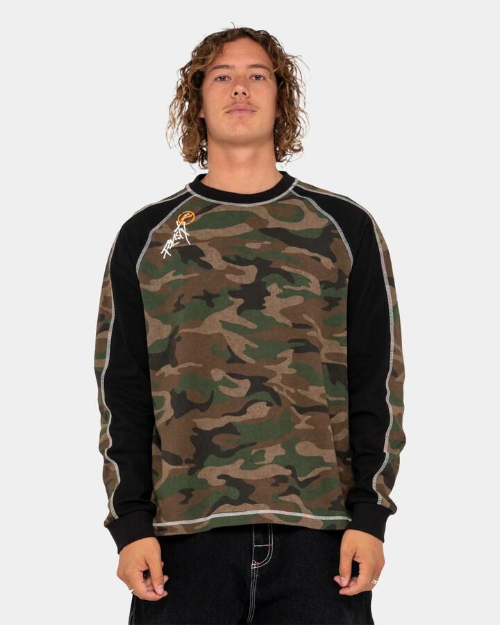 Image of a model wearing Tops. Product name - Rusty Mens Woof Raglang Long Sleeve T-Shirt Camo in Camo colour by brand - Rusty