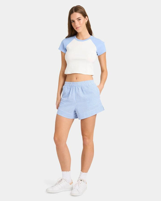 Image of a model wearing Shorts. Productname: Nunui - Womens Carnival Check Elastic Waist Shorts - Dusty Blue - in Dusty Blue colour by brand - Nunui