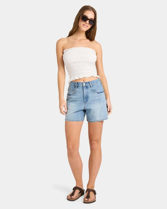 Image of a model wearing Tops. Productname: Nunui - Womens Sundae Shirred Tube Top - White - in White colour by brand - Nunui