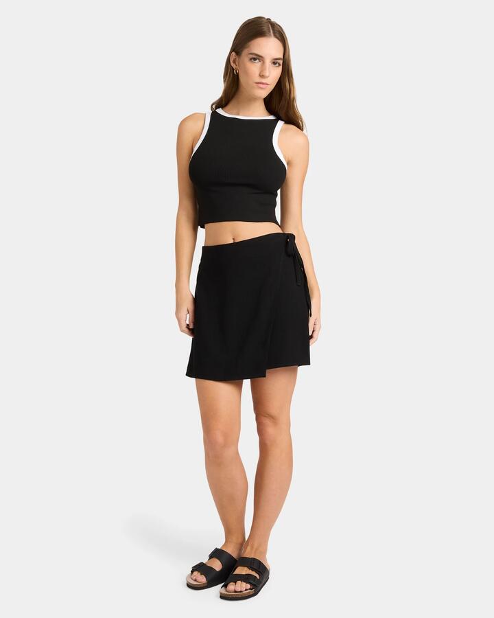 Image of a model wearing Skirts. Product name - Nunui Womens Tied Up Skirt Black in Black colour by brand - Nunui
