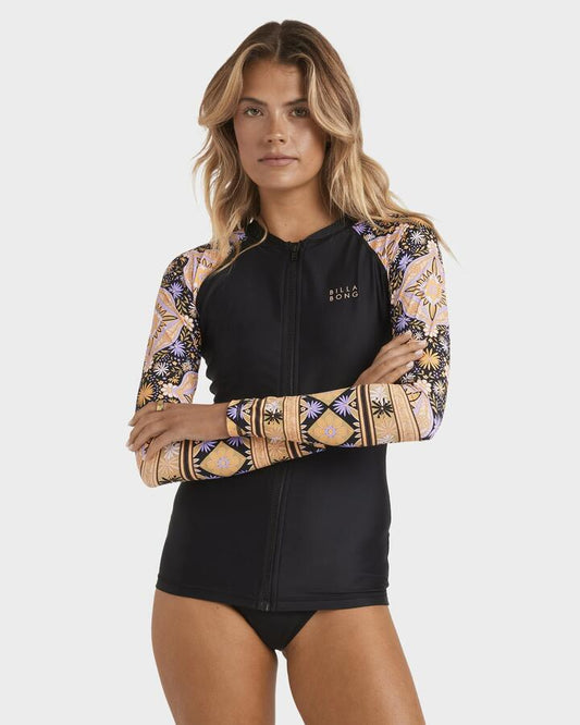 Image of a model wearing Tops. Product name - Billabong Womens Pipa Upf 50 Long Sleeve Rash Vest Black in Black colour by brand - Billabong