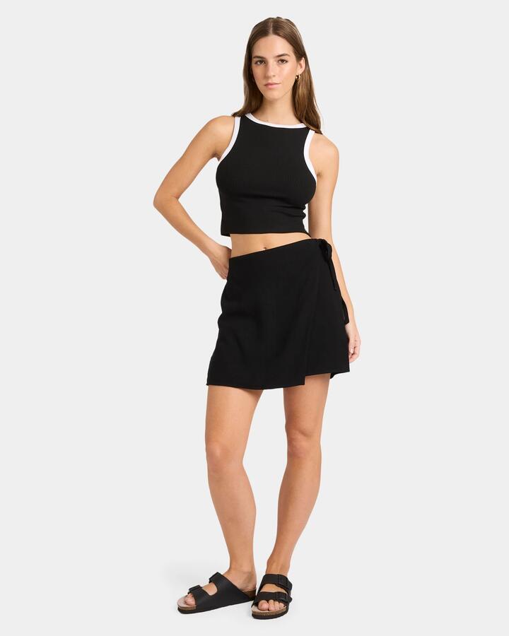 Image of a model wearing Tops. Productname: Nunui - Womens Boy Crop Tank - Black / White - in Black / White colour by brand - Nunui