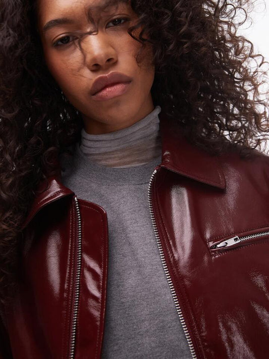 Image of a model wearing Outerwear. Productname: Topshop Faux Leather Vinyl Bomber Jacket in Burgundy colour by brand - Topshop