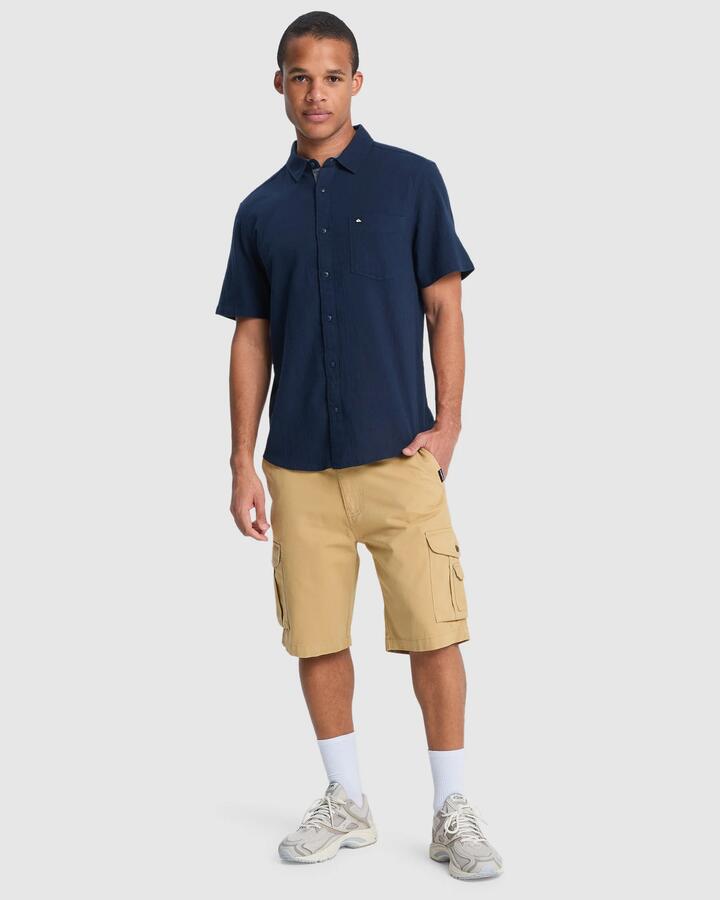 Image of a model wearing Shorts. Product name - Quiksilver Mens Crucial Battle Cargo 21" Walkshorts Khaki in Khaki colour by brand - Quiksilver
