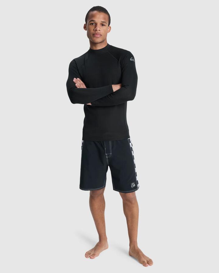 Image of a model wearing Tops. Product name - Quiksilver Mens Heat Long Sleeve Rash Vest Black in Black colour by brand - Quiksilver