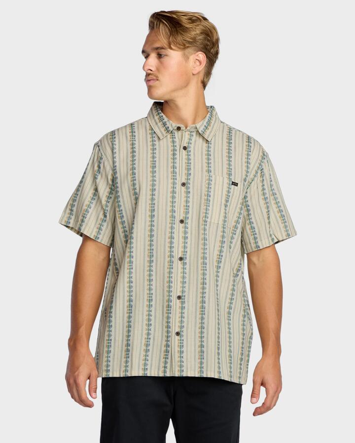 Image of a model wearing Tops. Product name - Billabong Mens Sundays Jaquard Short Sleeve Shirt Cream in Cream colour by brand - Billabong