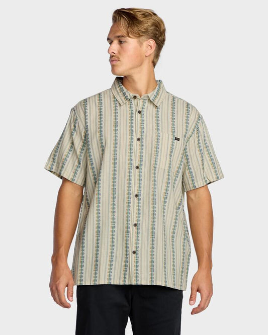 Image of a model wearing Tops. Product name - Billabong Mens Sundays Jaquard Short Sleeve Shirt Cream in Cream colour by brand - Billabong