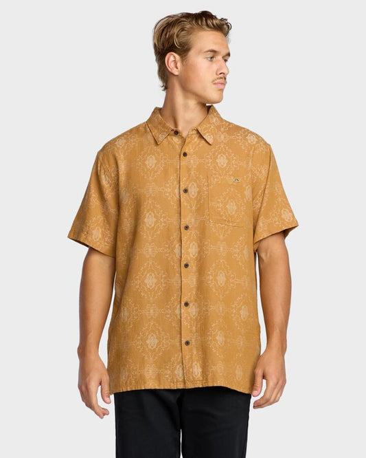 Image of a model wearing Tops. Product name - Billabong Mens Sundays Jaquard Short Sleeve Shirt Golden Haze in Golden Haze colour by brand - Billabong