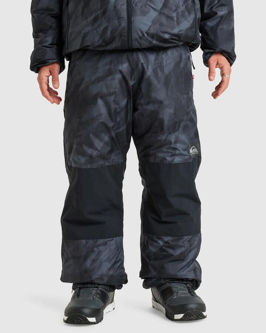 Image of a model wearing Pants. Productname: Quiksilver - Mens Travis Rice Expedition Snow Pants - Tr Black Paper - in Tr Black Paper colour by brand - Quiksilver