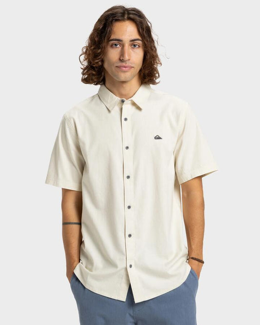Image of a model wearing Tops. Productname: Quiksilver Mens Premium Stretch Short Sleeve Shirt Bone White - in Bone White colour by brand - Quiksilver