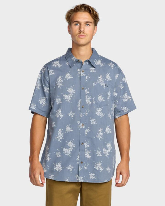 Image of a model wearing Tops. Productname: Billabong Mens Sundays Mini Short Sleeve Shirt Steel Blue - in Steel Blue colour by brand - Billabong