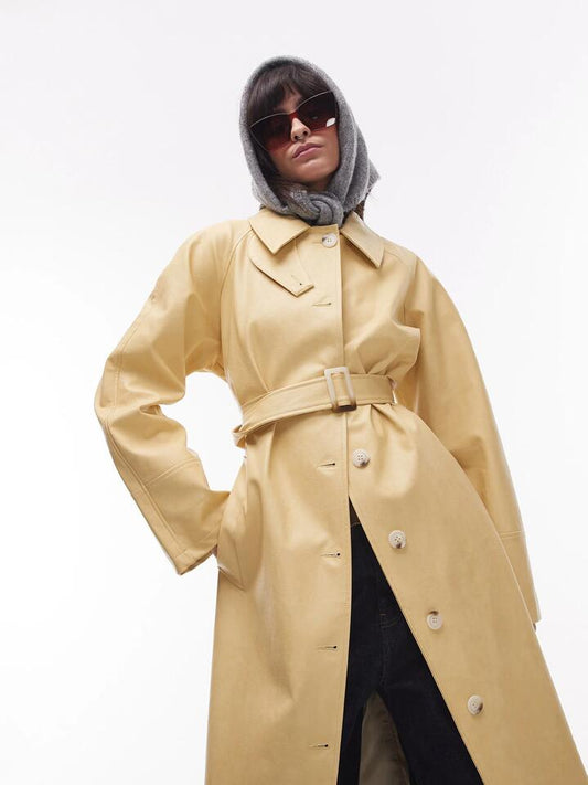 Image of a model wearing Outerwear. Productname: Topshop Long Oversized Leather Trench in Buttermilk colour by brand - Topshop