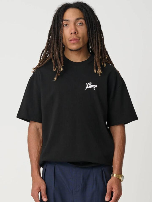 Image of a model wearing Tops. Productname: Xlarge Folded Crown Tee in SOLID BLACK colour by brand - Xlarge