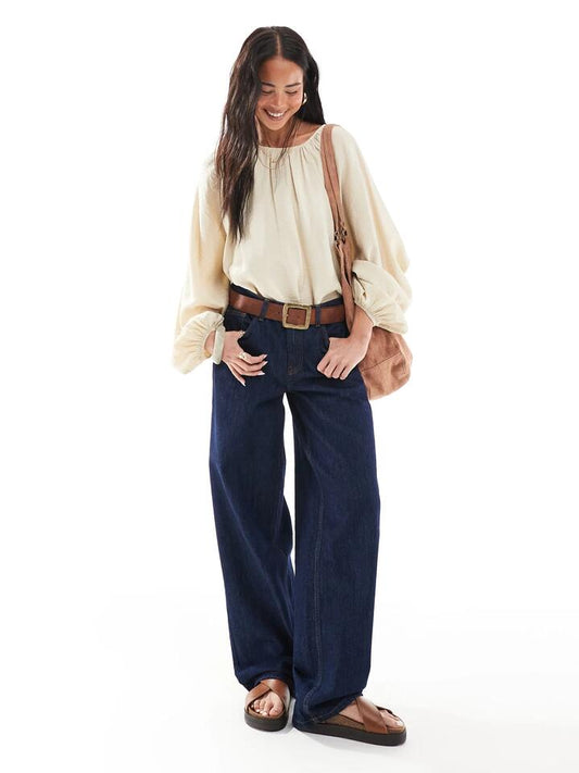 Image of a model wearing Denim. Productname: Topshop Low Rise Cinch Back Jeans in Raw Indigo colour by brand - Topshop