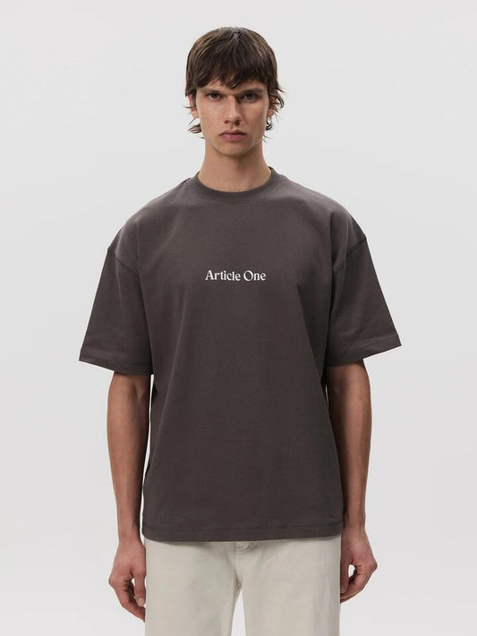 Image of a model wearing Tops. Productname: Article One Mariposa Logo Tee in Obsidian colour by brand - Article One