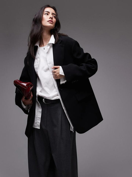 Image of a model wearing Outerwear. Productname: Topshop Oversized Slouchy Blazer in Black colour by brand - Topshop