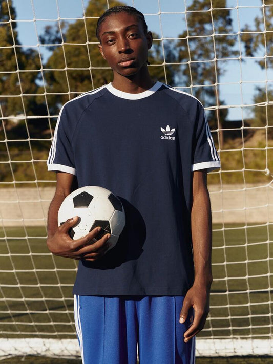 Image of a model wearing Tops. Productname: Adidas Adicolor Classics 3-Stripes T-Shirt in Night Indigo colour by brand - Adidas