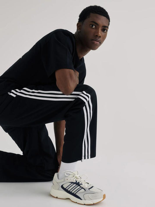 Image of a model wearing Pants. Productname: Adidas Adicolor Classics Firebird Track Pants in Black/White colour by brand - Adidas
