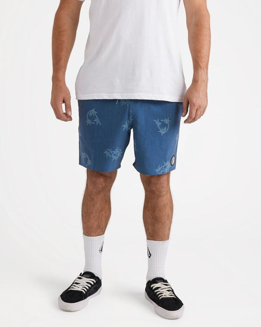 Image of a model wearing Shorts. Productname: Volcom - Mens Regal Trop Psych Cotton 17" Swim Shorts - Coronet Blue - in Coronet Blue colour by brand - Volcom