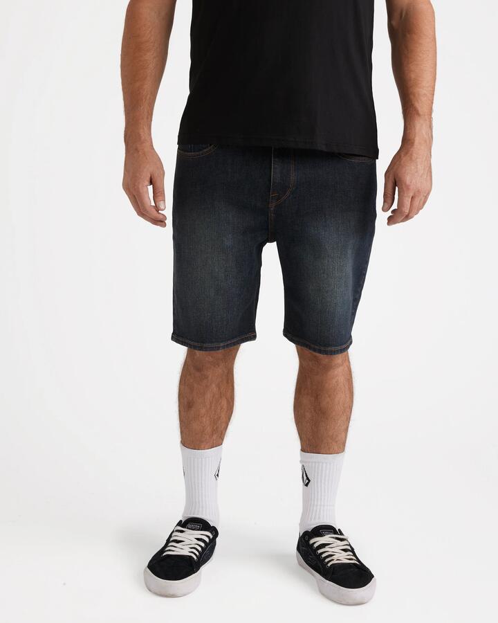 Image of a model wearing Shorts. Productname: Volcom - Mens Solver 19" Denim Shorts - New Vintage Blue - in New Vintage Blue colour by brand - Volcom