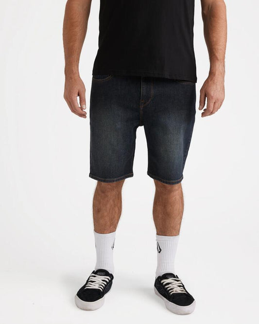 Image of a model wearing Shorts. Productname: Volcom - Mens Solver 19" Denim Shorts - New Vintage Blue - in New Vintage Blue colour by brand - Volcom