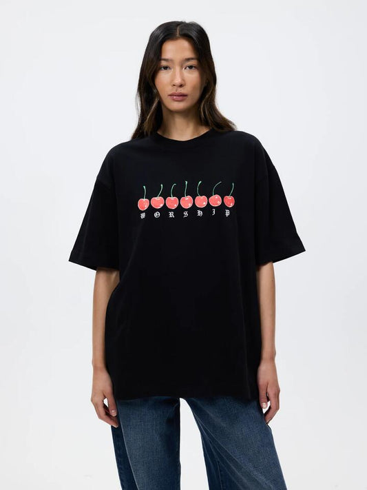 Image of a model wearing Tops. Productname: Worship Cherio Oversized Tee in BLACK colour by brand - Worship