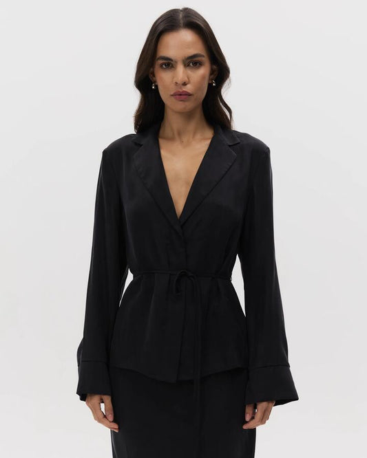 Image of a model wearing Tops. Productname: Lulu & Rose Chere Cupro Wrap Blouse in Black colour by brand - Lulu & Rose