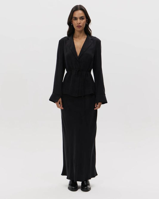 Image of a model wearing Skirts. Productname: Lulu & Rose Chere Cupro Midi Skirt in Black colour by brand - Lulu & Rose