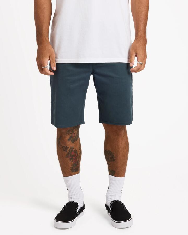 Image of a model wearing Shorts. Product name - Volcom Mens Solver Lite 5 Pocket 19" Shorts Dark Slate in Dark Slate colour by brand - Volcom
