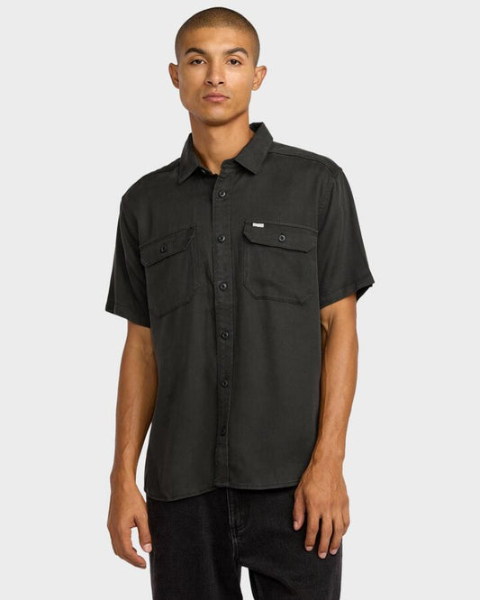 Image of a model wearing Tops. Productname: RVCA - Mens Vacancy Utility Short Sleeve Shirt - Pirate Black - in Pirate Black colour by brand - RVCA