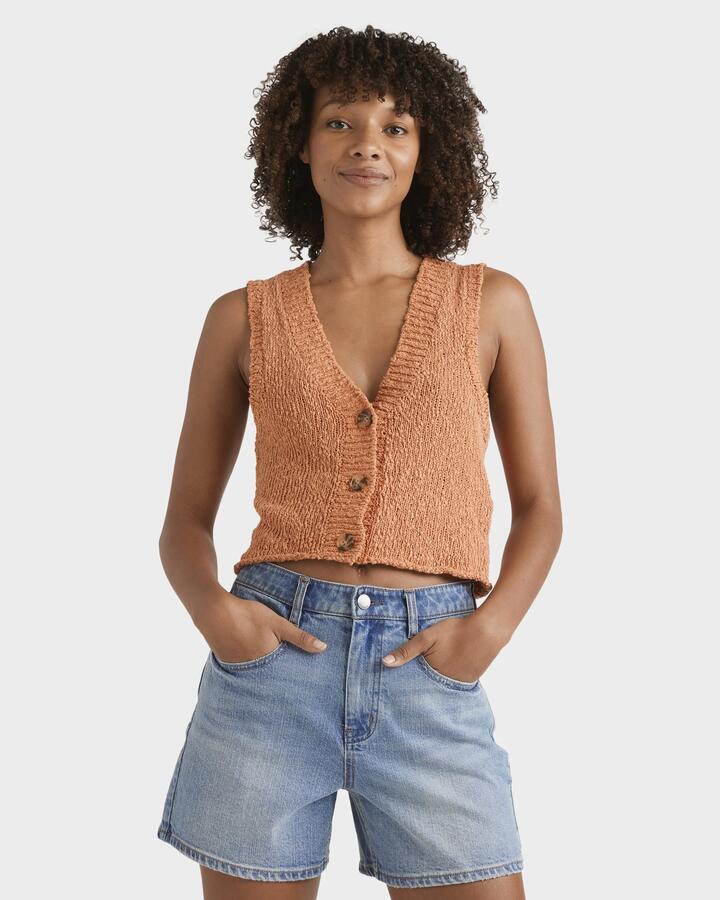 Image of a model wearing Outerwear. Productname: Billabong Womens Gia Sweater Vest Top Sunset - in Sunset colour by brand - Billabong