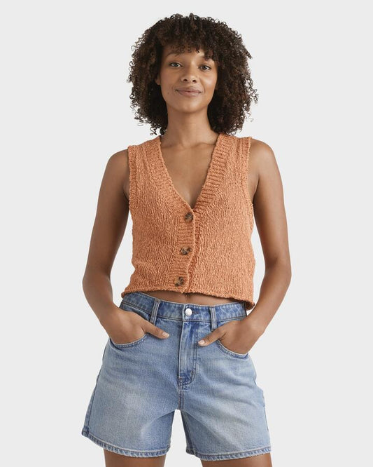 Image of a model wearing Outerwear. Productname: Billabong Womens Gia Sweater Vest Top Sunset - in Sunset colour by brand - Billabong