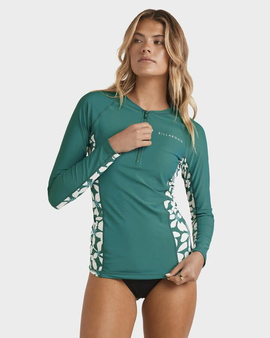 Image of a model wearing Tops. Product name - Billabong Womens Reek Break Upf 50 Long Sleeve Rash Vest Evergreen in Evergreen colour by brand - Billabong