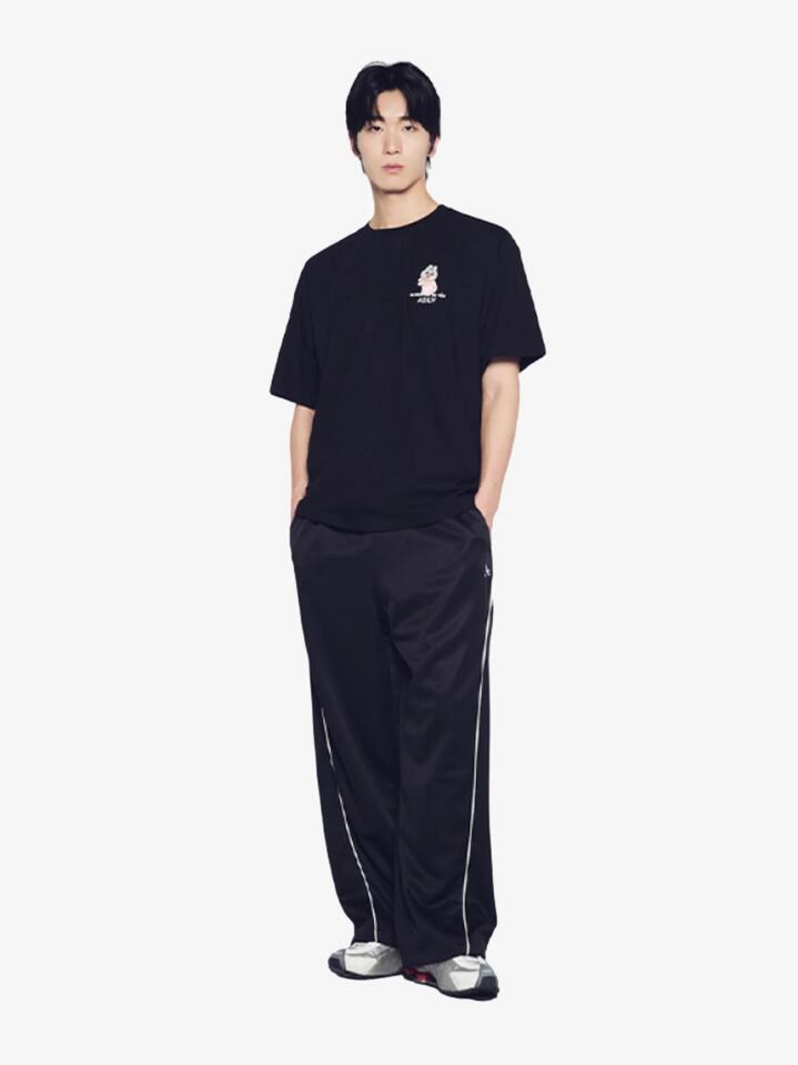Image of a model wearing Shorts. Productname: ADLV Tanning Opanchu Basic Logo Short Sleeve T-Shirt in Black colour by brand - ADLV