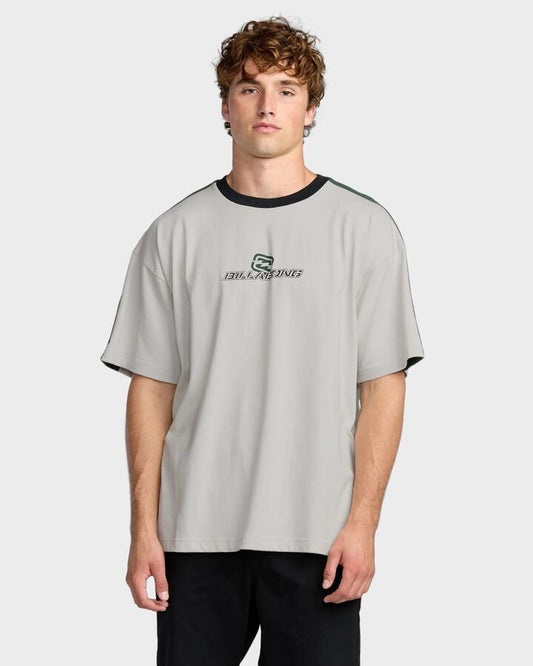 Image of a model wearing Tops. Productname: Billabong - Mens Spec 73 Iconic T-Shirt - Silver - in Silver colour by brand - Billabong
