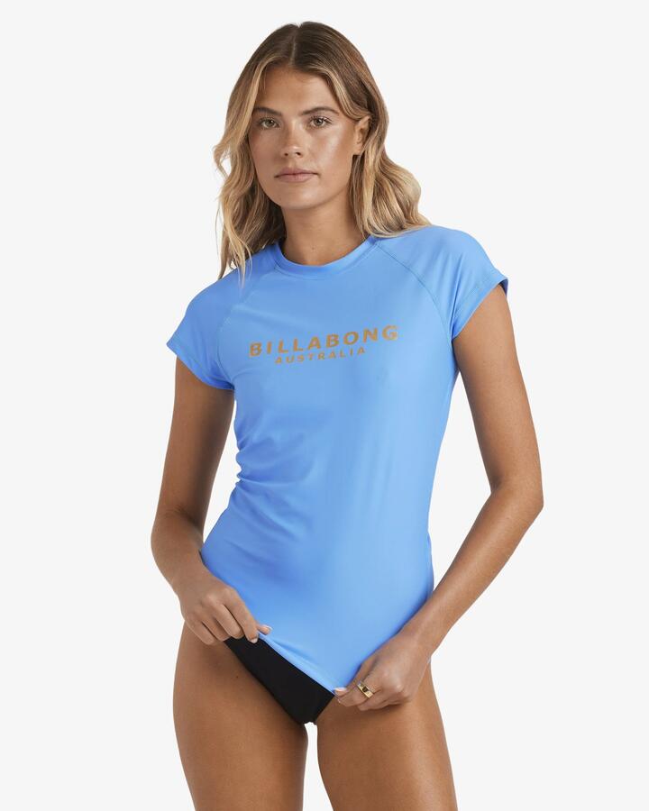 Image of a model wearing Tops. Productname: Billabong Womens Society Foil Short Sleeve Rash Vest Tidal Blue - in Tidal Blue colour by brand - Billabong