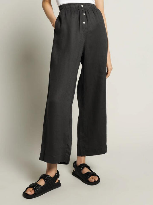 Image of a model wearing Pants. Productname: Nude Lucy Nude Linen Lounge Crop Pant in Coal colour by brand - Nude Lucy