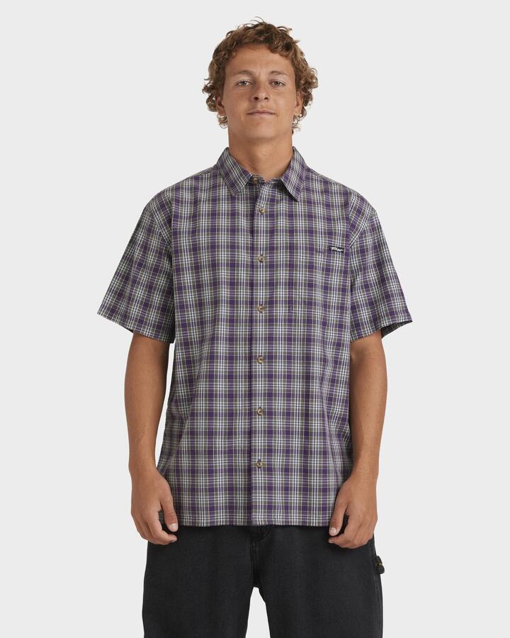Image of a model wearing Tops. Product name - Billabong Mens Mogul Short Sleeve Shirt Deep Purple in Deep Purple colour by brand - Billabong