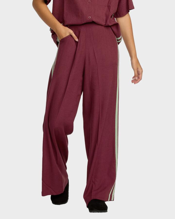 Image of a model wearing Pants. Product name - RVCA Womens Syd Stripe Elastic Waist Pants Wine in Wine colour by brand - RVCA