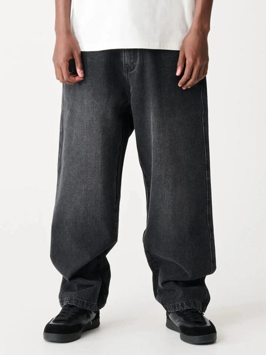 Image of a model wearing Denim. Productname: Xlarge Bull Denim 91 Pant in Worn Black colour by brand - Xlarge