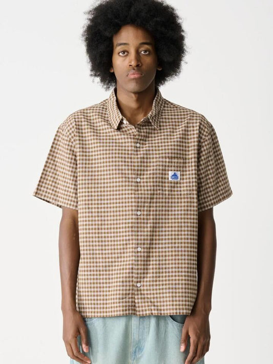 Image of a model wearing Shorts. Productname: Xlarge Max Short Sleeve Shirt in Brown colour by brand - Xlarge