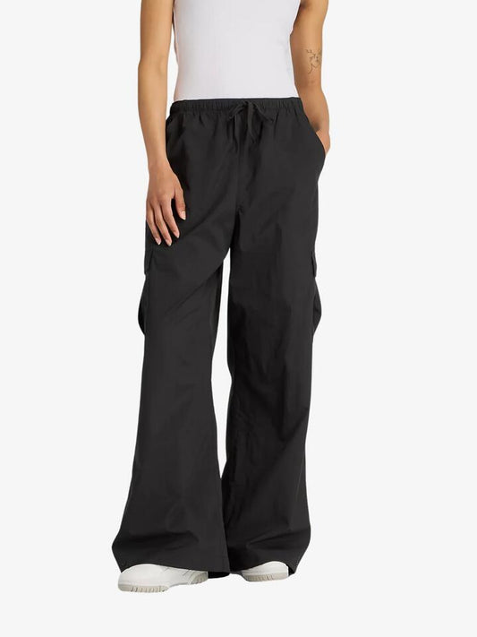 Image of a model wearing Pants. Productname: New Balance Woven Cargo Pants in Black colour by brand - New Balance