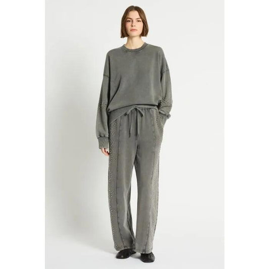 Image of a model wearing Outerwear. Productname: Raceway Embellished Sweat Pant in Acid Wash colour by brand - sass and bide