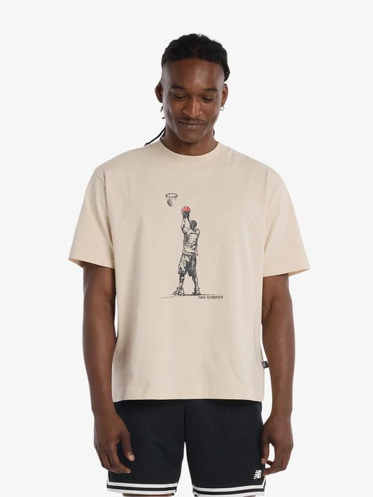 Image of a model wearing Tops. Productname: New Balance Hoops Player Graphic T-Shirt in Bisque colour by brand - New Balance